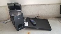 Panasonic Blu-Ray player with remote and six-piece surround speaker set including subwoofer and five satellite speakers