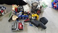 Wide shot displaying the entire lot including motor oils, jack, jack stands, wheels and various cleaning supplies.
