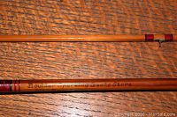 Close-up of bamboo fly rod section showing inscription 'Boulder Sporting Goods Store'.