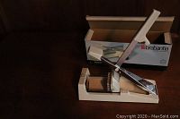Photo showing Brabantia French Fry Cutter with original box on wooden surface