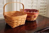 Wide shot showing both baskets side by side on a wooden surface with a white window backdrop.