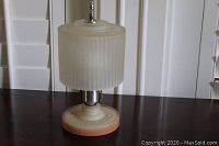 Vintage Vaseline ceiling light fully assembled, showing ribbed glass shade and base on table surface.