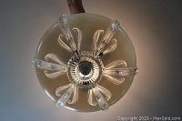 Top view of one pressed glass chandelier showing detailed pressed glass pattern and central fixture.