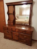 Front view of pine dresser with attached mirror and shelving unit on left side.