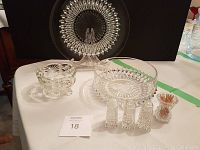 Wide image showing all crystal items on table including platter, bowl, candy dish, pair of shakers, and toothpick holder
