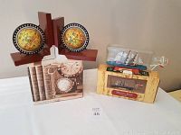 Overview of globe bookends and boxed ship in bottle on a table