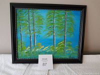Framed oil painting of trees with blue sky background, painted by local Cobourg artist.