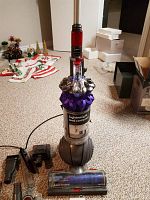Front view of Dyson Ball upright vacuum showing purple cyclone housing and grey Ball base