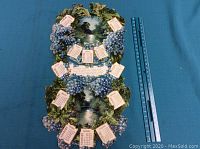 Full view of the 1910 calendar showing all months and central nature scene with floral decoration