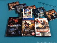 Top-down photo of 8 video game cases arranged in 2 rows.