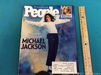 Front cover of People magazine special double issue featuring Michael Jackson dancing and inset photo of Farah Fawcett