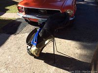 Side view of the Taylor Made golf bag with stand deployed and club cover on top showing brand and color details