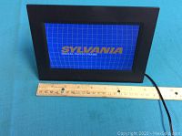 Front view of the Sylvania digital photo frame showing the display screen with brand logo.