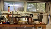 Wide view of workbench with several hand and power tools including saws, clamps, and small hardware items.