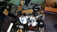 View of the lot spread on floor showing framed prints, jerseys, hats, scarf, posters and bobbleheads
