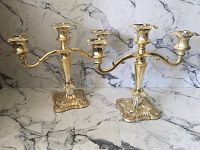 Pair of vintage brass candelabras photographed together, showing overall shape, size, and condition.