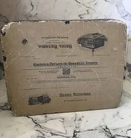 Lithographic stone surface with printed text and images, showing wear and scratches.