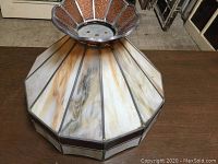 Top and side view of large stained glass lamp shade with metal frame and amber glass decorative basket top section.