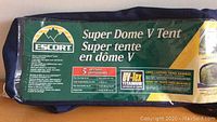Photo of packaging label showing Escort Super Dome V 5 person tent specifications and UV-Tex Titanium fabric feature.