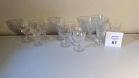 All crystal stemware glasses arranged in 2 rows showing full view of items.