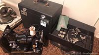 Singer Featherweight machine out of case with accessories laid out