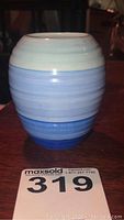 Image of Shelley Harmony blue banded ceramic vase about 3.5 inches tall showing front and color gradient from light to dark blue bands.