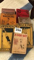 Group shot of six vintage sports books arranged on floor