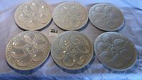 Overhead view of all six oyster plates arranged on white cloth