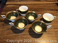 Photo showing four Coalport Lady Anne green and gold decorated tea cups and two Coalport Athlone green cups on table