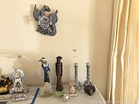 Overhead view of all items on display including ceramic figures, candlesticks, music box, and clock