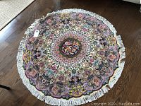 Top-down view of entire round rug on hardwood floor