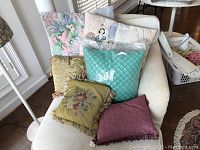 Full view of all throw pillows displayed on a white couch showing textures and colors