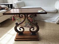 Front view of rosewood pedestal table in room setting