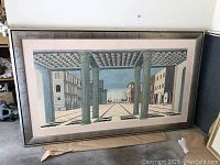 Full frontal view of large rectangular framed Renaissance-style perspective landscape artwork with columns and buildings.