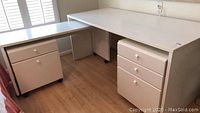 Photo showing the modular desk with main desk portion and side section on wheels with file cabinets underneath.