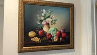 Full view of framed still life painting showing floral arrangement and fruit