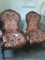 Pair of vintage chairs including an armchair and an armless parlour chair upholstered in red and cream raised velour fabric with carved wooden frames