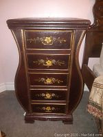 Front view of curved bombe-shaped mini dresser showing five floral-decorated drawers