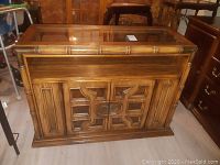 Close-up of door detailing with geometric pattern and oval metal handles.