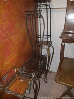 Group view showing two lattice‐style stands and one bench‐style in dark metal finish