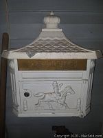 Frontal view showing the embossed horse rider design and brass 'LETTERS' slot, white chipped paint visible