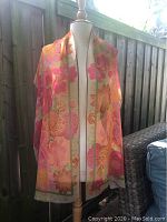 Full length of scarf displayed on mannequin showing floral design and overall color scheme.