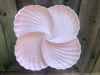 Top view of the pink shell shaped tray showing entire shell design and scalloped edges.