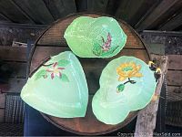 Top view of three CarltonWare ceramic pieces showing unique shapes and floral designs