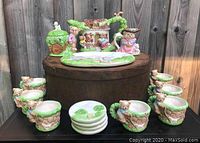 Full tea set displayed with all cups, plates, creamer, sugar bowl, serving tray, and teapot.