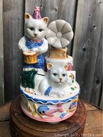 Front view of the musical cat figurine showing the cat with drum and lying cat with gramophone horn behind, showcasing the figure and detail.