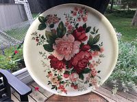 Front of large round serving tray with detailed English rose floral design on cream background.