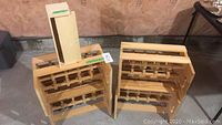 Shows two wooden wine racks and the wooden boxes stacked on top or nearby, providing an overview of the lot contents and condition.
