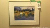 Framed watercolor artwork showing detailed landscape scene including trees, water, and reflection.