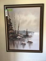 Full view of the framed oil painting showing a natural landscape scene with bare and evergreen trees by water.